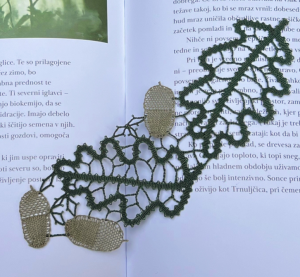 Photo of acorn and leaves made out of lace, laid on a book