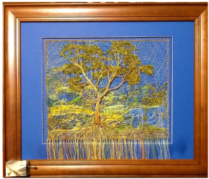Lace tree on blue background with red wooden frame
