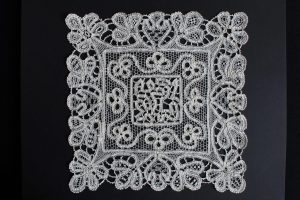 White needlelace on black background